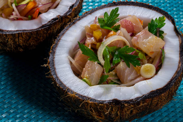 Ceviche dish - appetiser of fresh fish marinated in citrus with tropical fruits served in a Coconut Bowls Ceviche dish - appetiser of fresh fish marinated in citrus with tropical fruits served in a Coconut Bowls. appetiser stock pictures, royalty-free photos & images