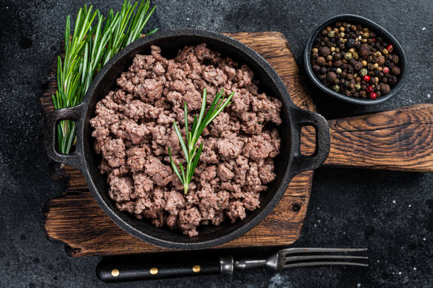 istock Fried mince beef meat in a pan for cooking pasta. Black background. Top view 1315054606