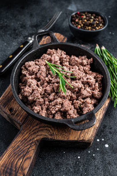 istock Fried mince beef meat in a pan for cooking pasta. Black background. Top view 1315054619