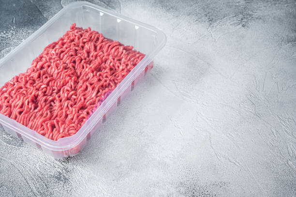 istock Fresh Raw mince beef and pork meat in vacuum packaging. White background. Top view. Copy space 1315054731