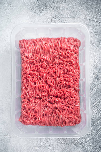 istock Fresh Raw mince beef and pork meat in vacuum packaging. White background. Top view 1315054747