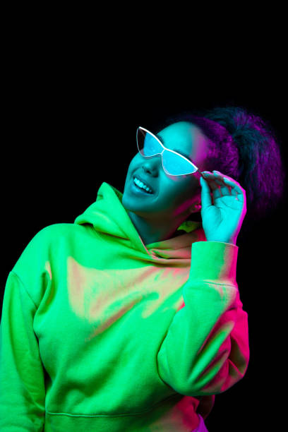 istock African-american woman's portrait isolated on dark studio background in multicolored neon light 1315058114