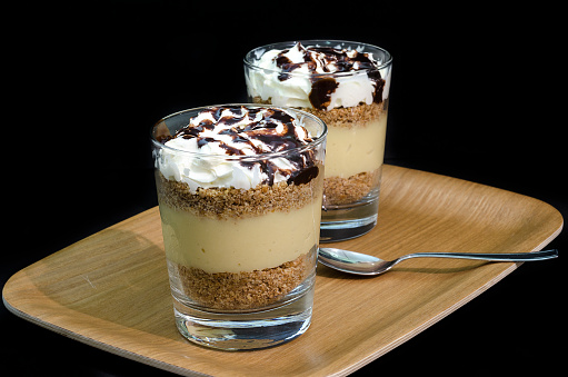 Glass with sweet biscuits with nutella cream and cream