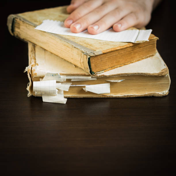 istock Hands of an young man holding a old book 1315059489