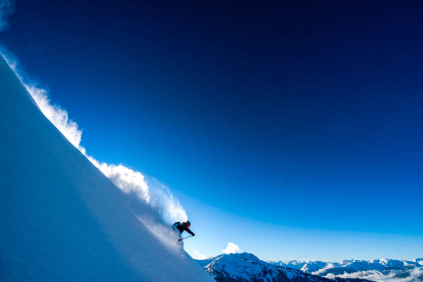 istock Skier descends steep mountain ridge through fresh powder snow 1315063670