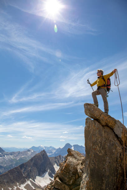 istock Mountaineer pauses on mountain peak in celebration 1315063900
