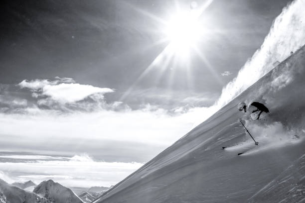 istock Skier descends steep mountain ridge through fresh powder snow 1315063997