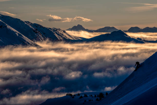 istock Skier descends steep mountain ridge at sunrise 1315064684