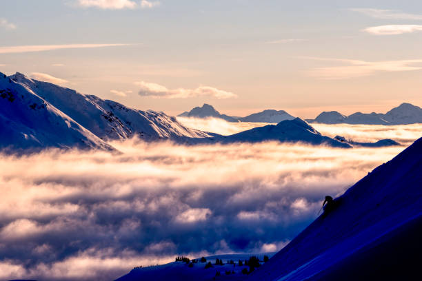istock Skier descends steep mountain ridge at sunrise 1315064715