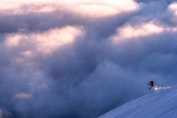 istock Skier gets air above sunlit clouds 1315064722