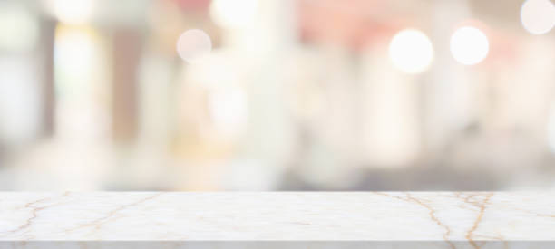 istock marble table top with blurred abstract cafe restaurant interior background 1315068164