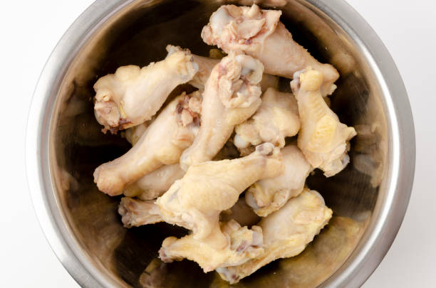 istock Boiled chicken drumettes in a stainless steel bowl on white background. 1315070078