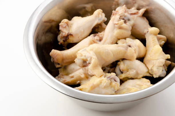 istock Boiled chicken drumettes in a stainless steel bowl on white background. 1315070092