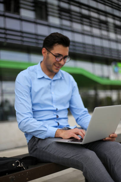 istock Business man using laptop while sitting on the bench. stock photo 1315070206
