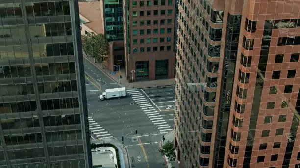 Aerial drone still of an intersection surrounded by office towers in the Westwood neighborhood of Los Angles, California.