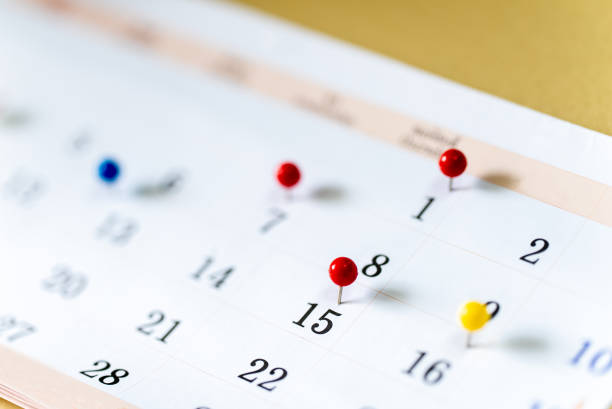 istock Closeup Colorful drawing pins on Calendar page with date 1315081164