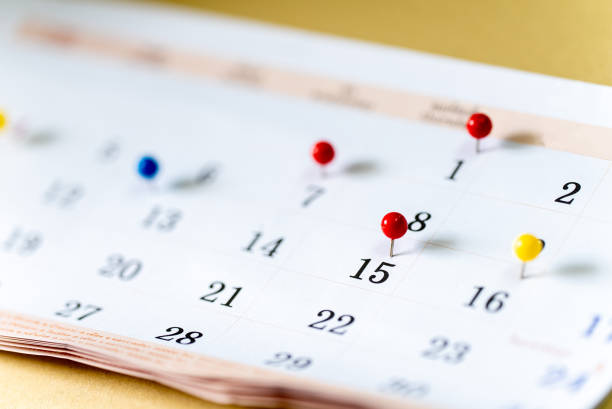 istock Closeup Colorful drawing pins on Calendar page with date 1315081247