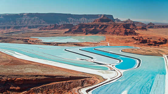 The blue-tinged Potash evaporation ponds stretch into the red rock formations of Moab, Utah.