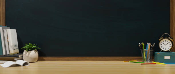 istock 3D rendering, study table in classroom with stationery, books, alarm clock and copy space on the table with chalkboard wall 1315095209