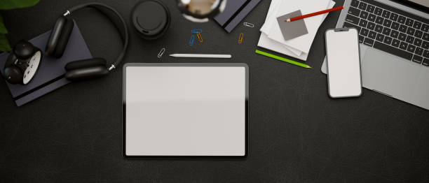 istock Top view, 3D rendering, dark creative flat lay workspace with tablet, laptop smartphone, accessories and supplies 1315095234
