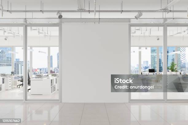 Modern Open Plan Office With White Blank Wall And Cityscape Background Stock Photo - Download Image Now