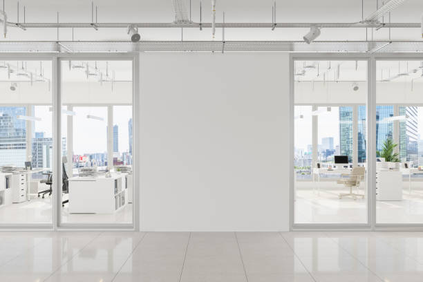 modern open plan office with white blank wall and cityscape background - moderno imagens e fotografias de stock