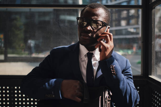 istock African businessman with smart phone on bus stop 1315110789