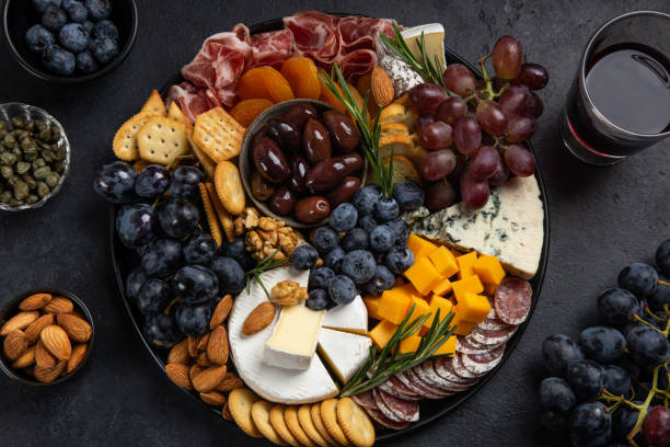 istock Appetizers boards with assorted cheese, meat, grape and nuts. Charcuterie and cheese platter. 1315110805