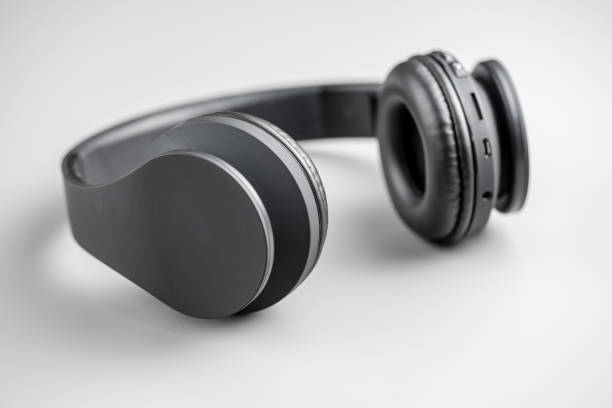 istock Gray wireless headphones on gray background. 1315111085
