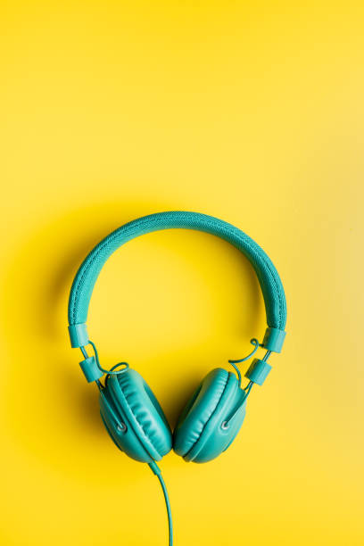 istock Colorful wired headphones on yellow background 1315111100