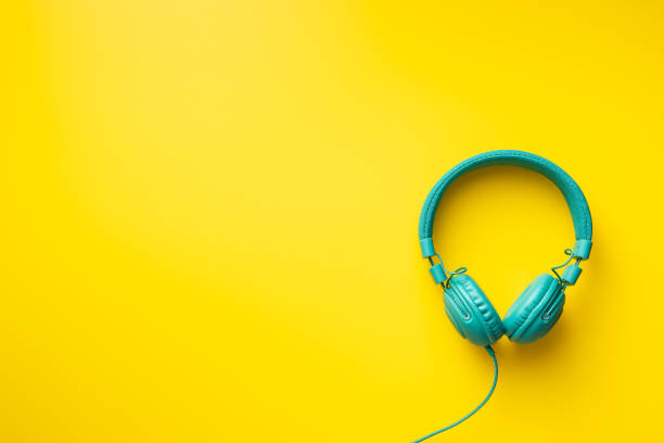 istock Colorful wired headphones on yellow background 1315111113