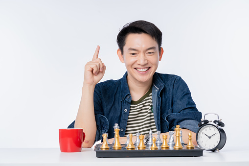 casual asian casual lifestyle male play chess board game with happiness and fun business strategy ideas concept