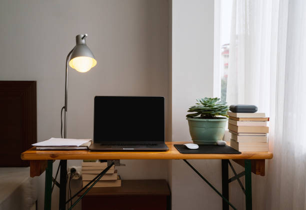 istock Simple home office setup with a table and laptop 1315114170