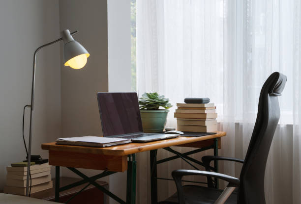 istock Simple home office setup with a table and laptop 1315114184