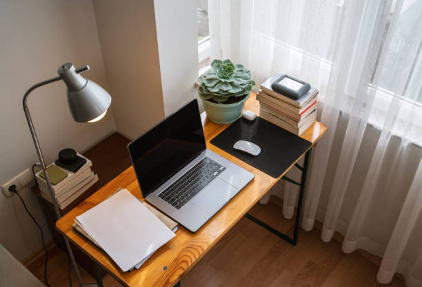 istock Simple home office setup with a table and laptop 1315114187