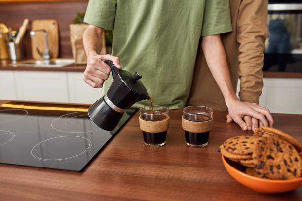 istock Young gay pair pouring coffee into cups 1315115204
