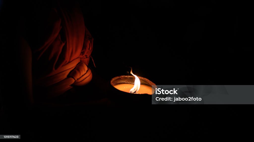 Buddhist monk hands holding candle cup in the dark ,Chiang mai , Thailand Asia Stock Photo Buddhist monk hands holding candle cup in the dark ,Chiang mai , Thailand Asia Stock Photo