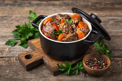 Close-up shot of authentic Indian lamb curry in a bowl on top of dining table