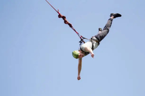 A man jumps from a bridge on a rope. Extreme sports.