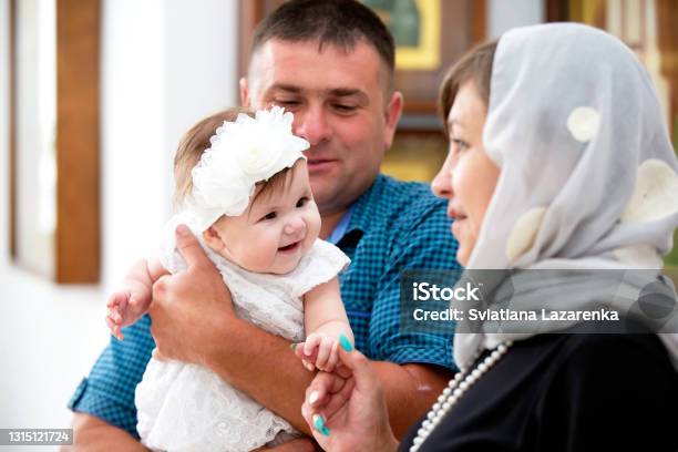 Baptism Of The Child Godfathers With A Child Stock Photo - Download Image Now - Baptism, Baby - Human Age, Priest