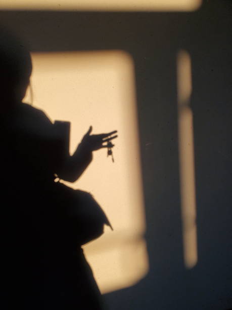 istock Blur shadowy silhouette holding bunch of keys in hand 1315122889