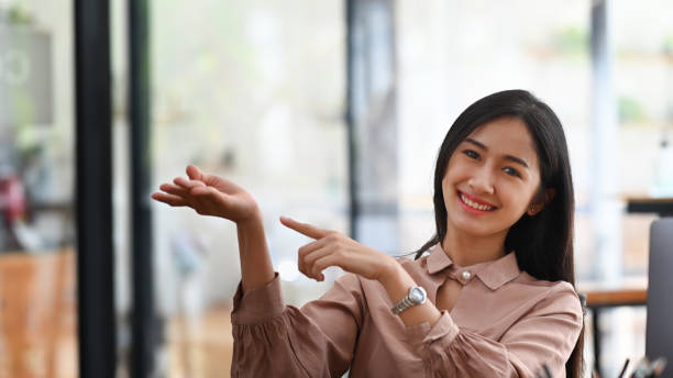 istock Young businesswoman smiling and presenting something. 1315123462