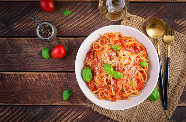 Spaghetti alla Amatriciana with guanciale, tomatoes and pecorino cheese. Italian healthy food. Top view, flat lay Spaghetti alla Amatriciana with guanciale, tomatoes and pecorino cheese. Italian healthy food. Top view, flat lay all'amatriciana stock pictures, royalty-free photos & images