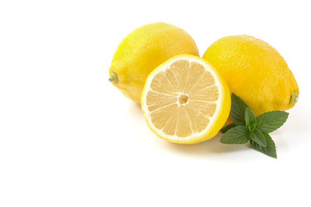 istock lemons whole and sliced, mint leaves, close-up on a white background, text space, horizontal view 1315129003
