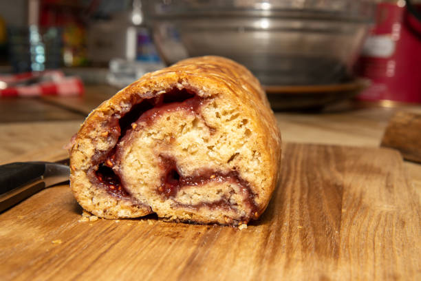 A delicious traditional British Jam Roly-Poly dessert on a wooden kitchen table