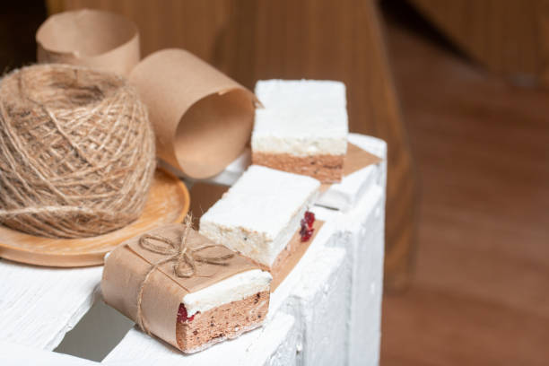 istock Portion marshmallow with cocoa and cranberries. Wrapped in paper and tied with string. Two-layer zephyr. 1315129708