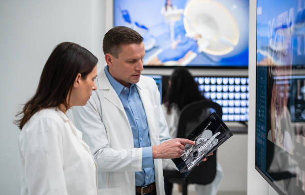 istock Doctors Consult Over An MRI Scan 1315131224