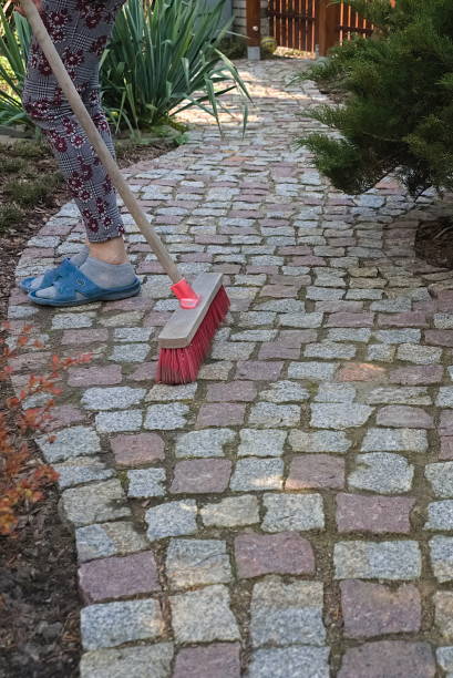 istock Sweeping a granite paving path in the spring garden 1315132731