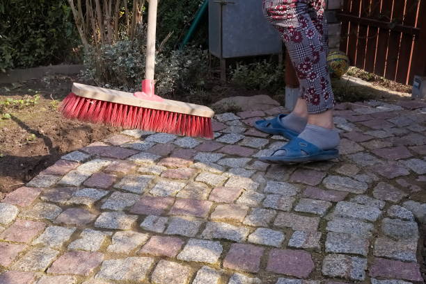 istock Sweeping a granite paving path in the spring garden 1315132736