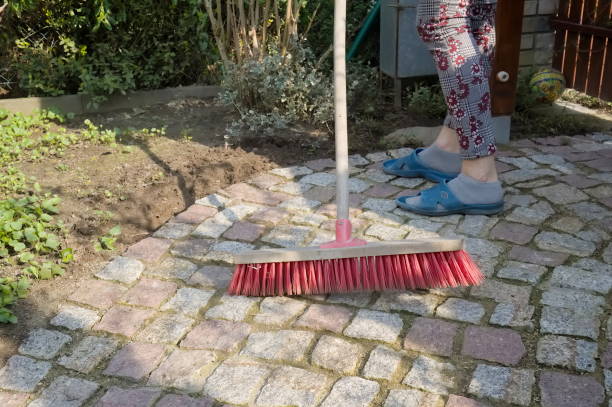 istock Sweeping a granite paving path in the spring garden 1315132741